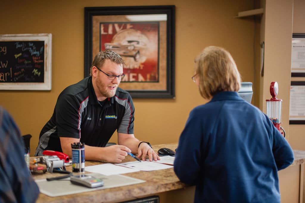 Photo of Staff Reviewing Car Estimate with Customer at McCormick Automotive Center in Fort Collins, Colorado