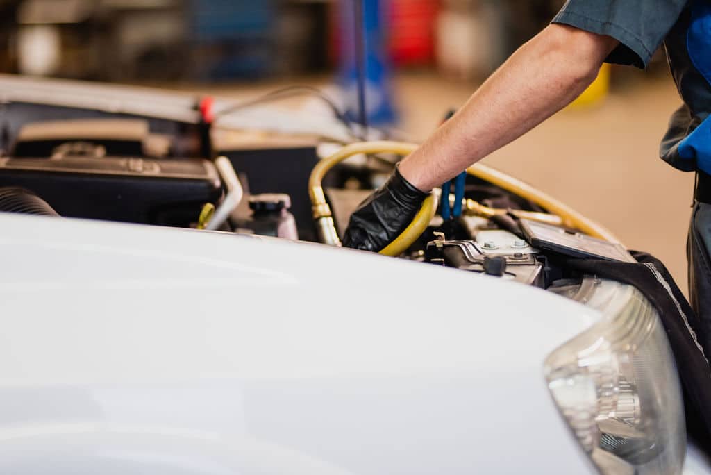 Photo of Mechanic Conducting Work on a Car Engine at McCormick Automotive Center in Fort Collins, Colorado